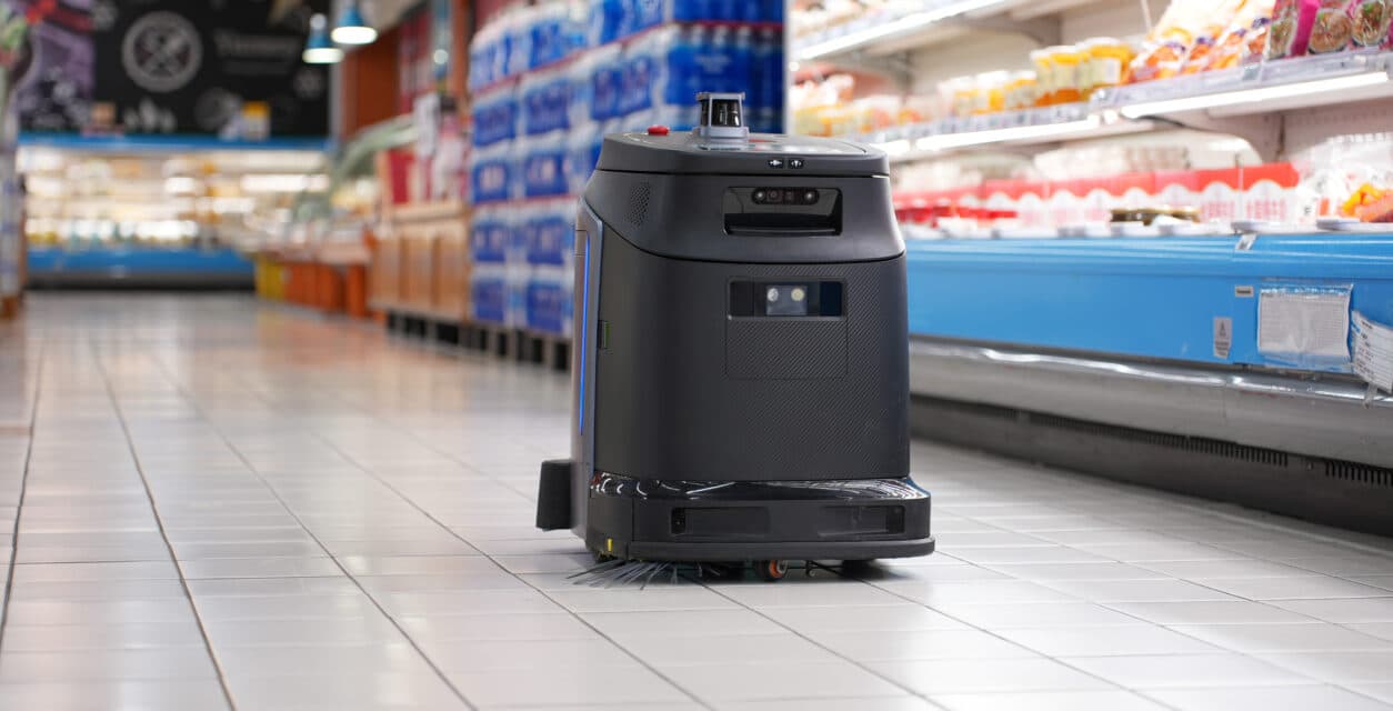 A Gausium Scrubber 75 cleaning robot working a retail corridor