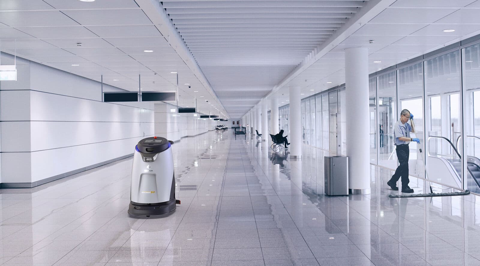 A Gausium Scrubber cleaning robot in an airport terminal concourse