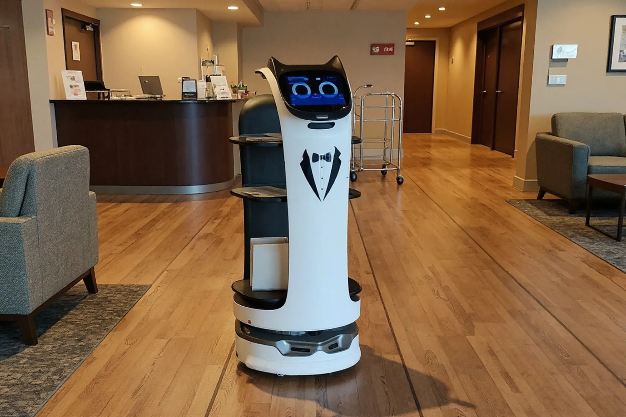 A delivery robot crossing a hotel lobby