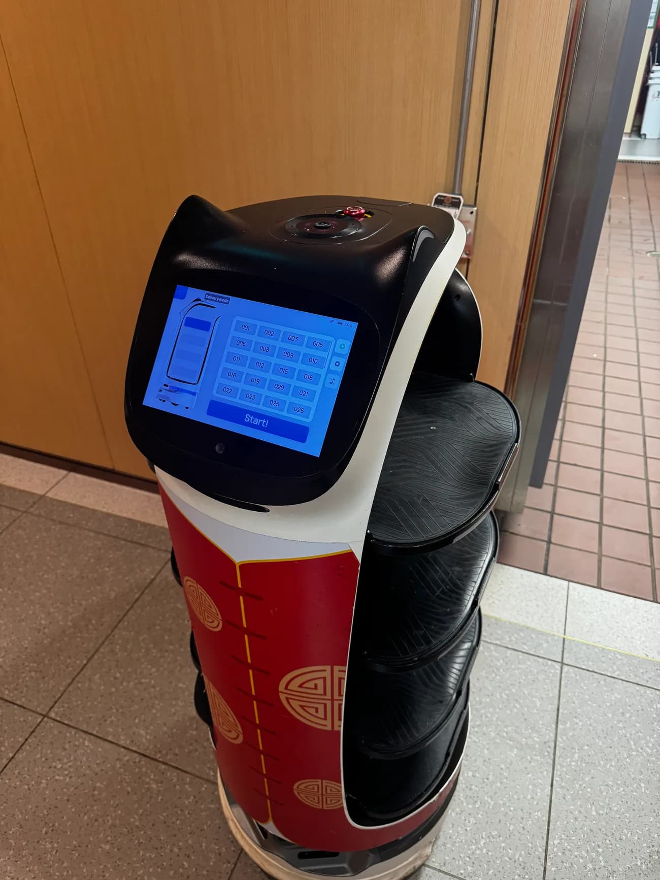 The Pudu delivery robot running plates at Haidilao San Diego