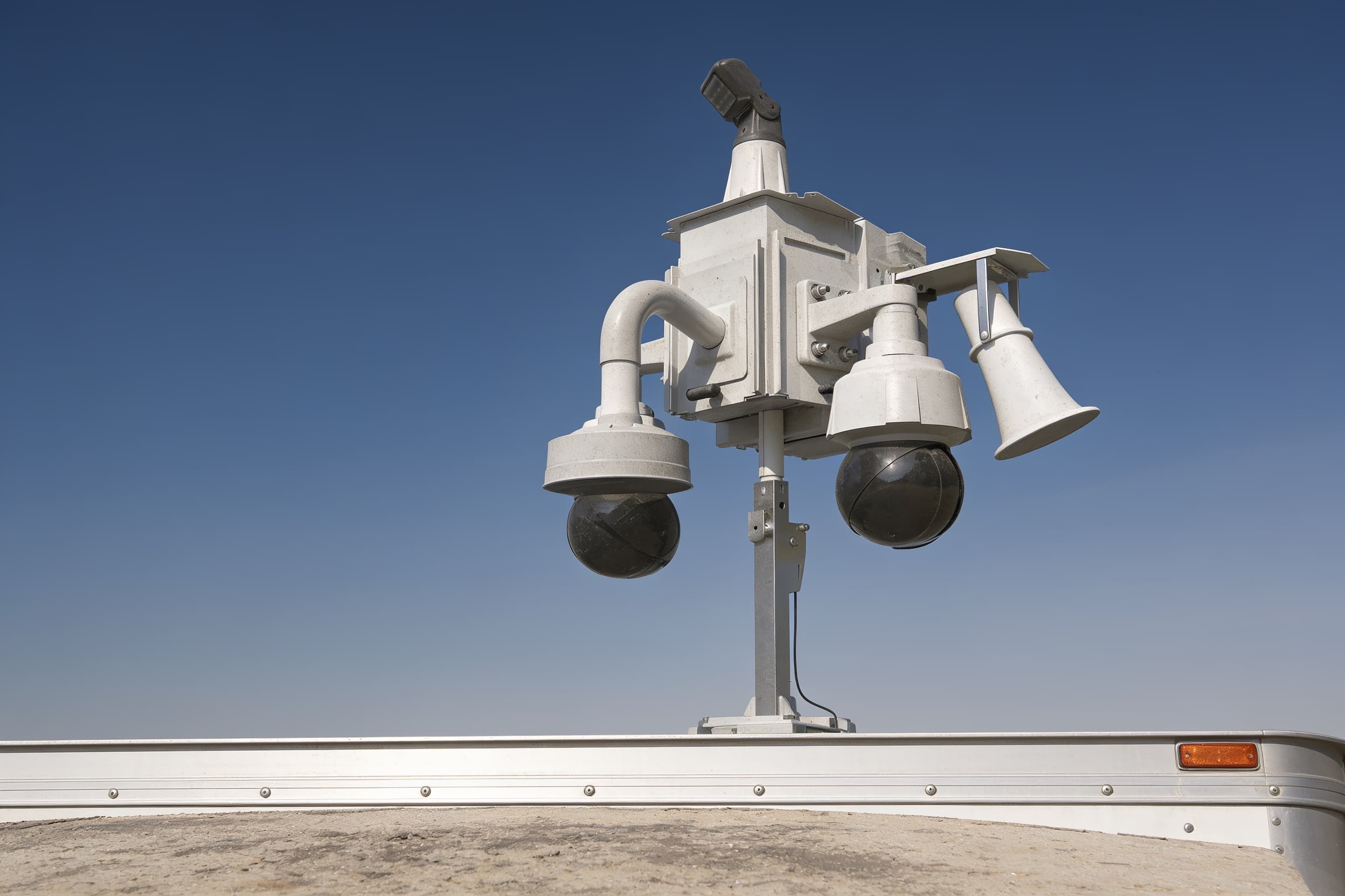 The dual-dome camera head atop a security-trailer mast