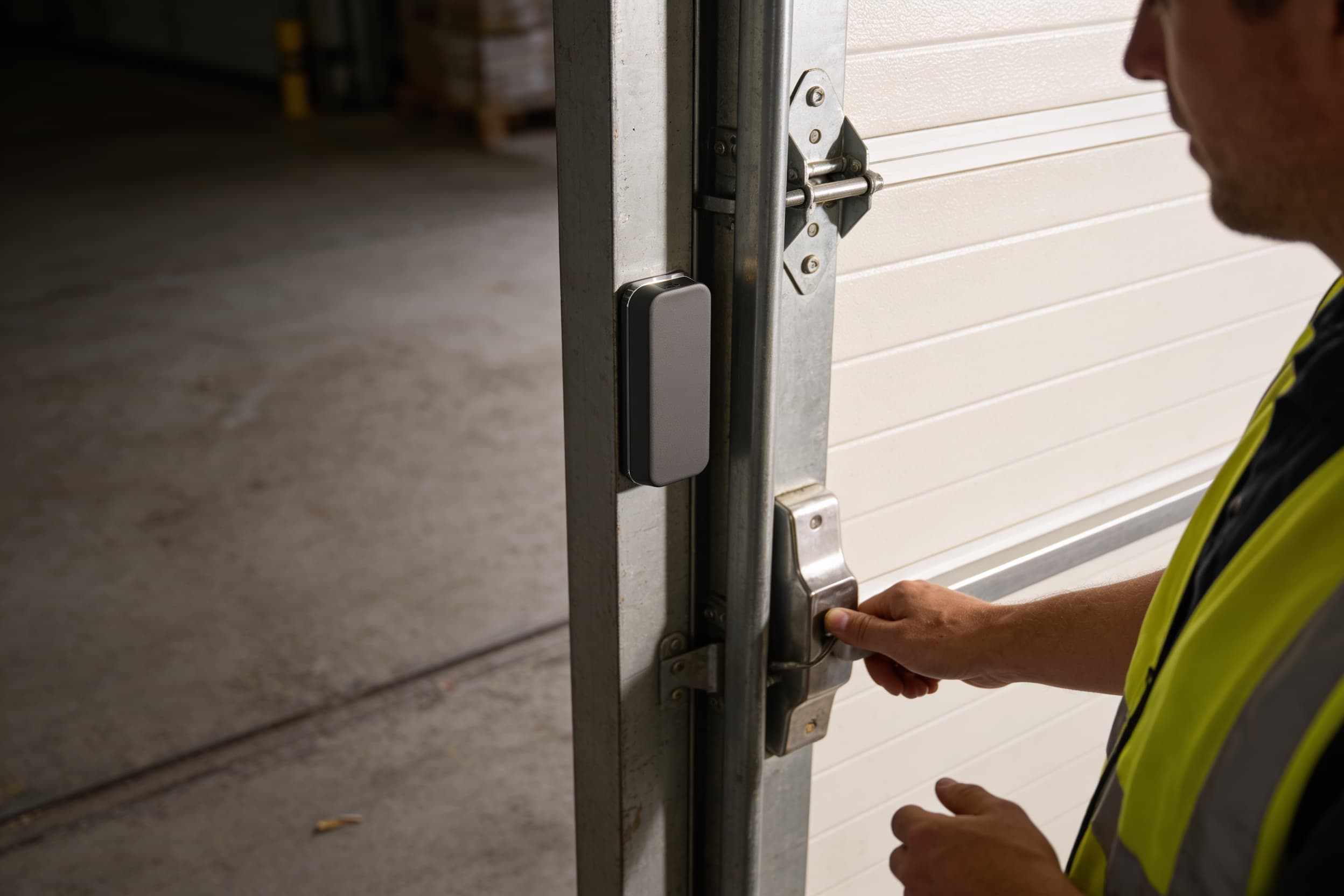 Worker badging through a steel warehouse door